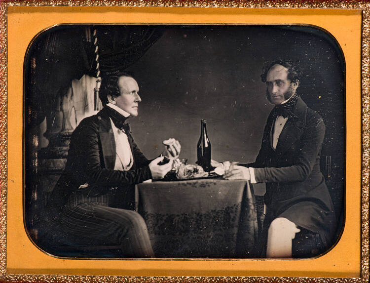 Gentlemen eating at table