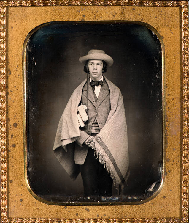 Schoolboy with shawl and books