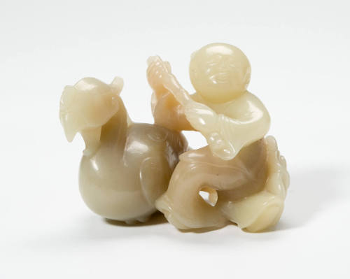 Boy Holding a Flute Kneeling Beside a Phoenix