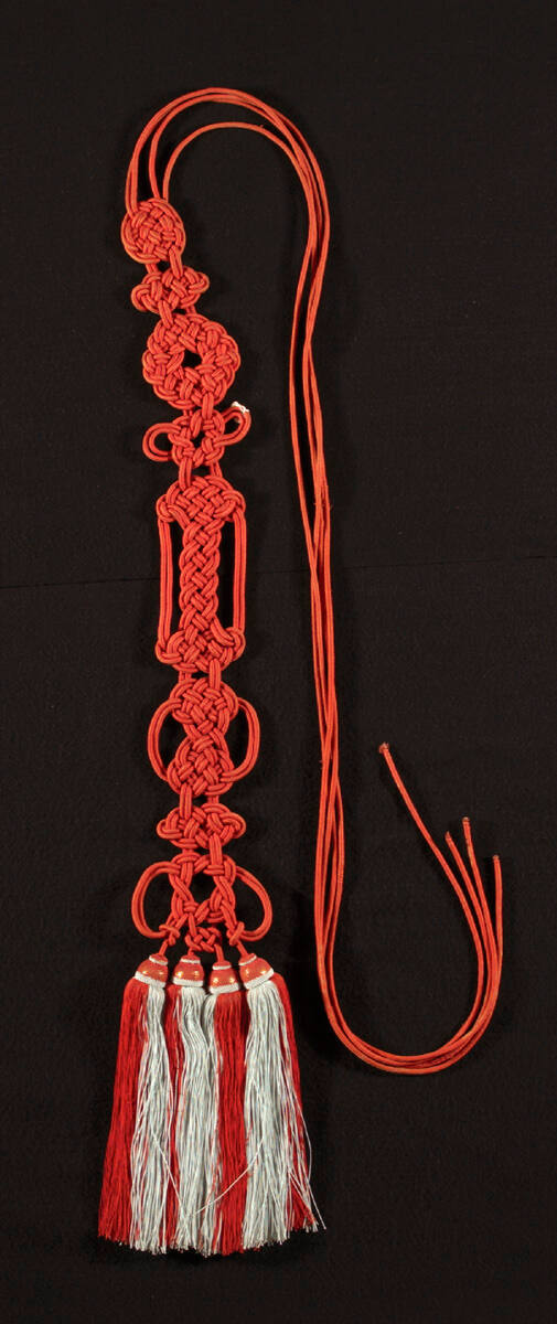 Buddhist monk's tassels with red and white stripes at bottom