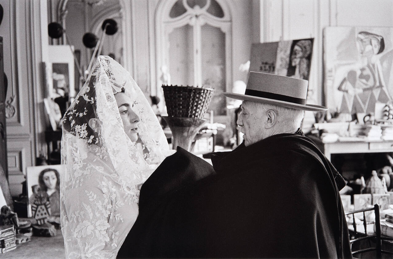 Jacqueline dressed in the mantilla of a Spanish Bride, and Pablo in a cape and hat