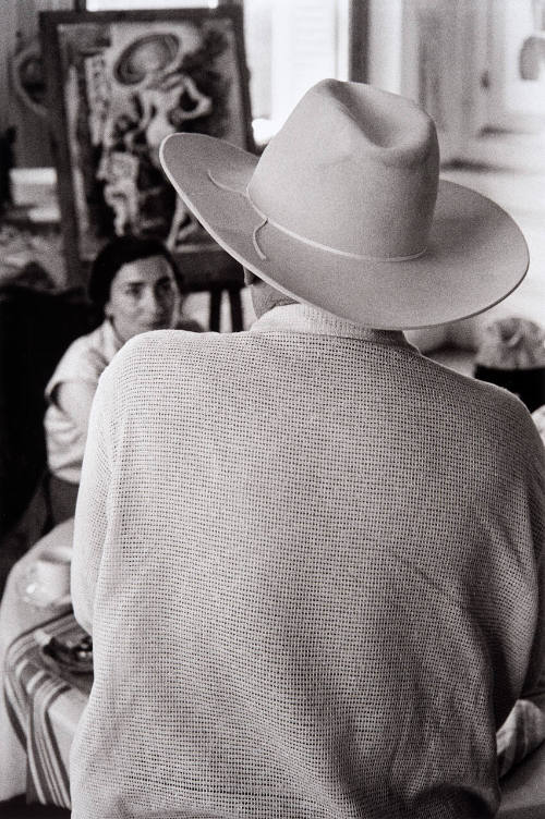 Picasso wearing Cooper's Stetson while talking with Jacqueline