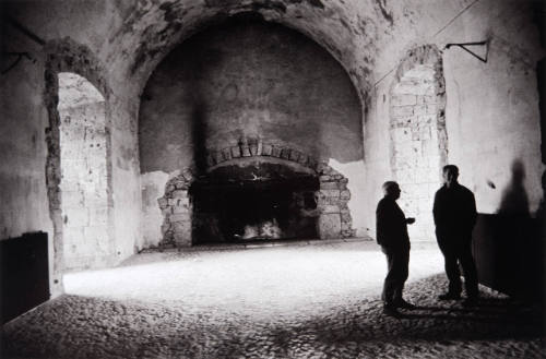 The vast ceremonial hall of the château dwarfing Picasso and his son Paulo, as the artist explains his daydream plans for the vaulted room, which he never touched