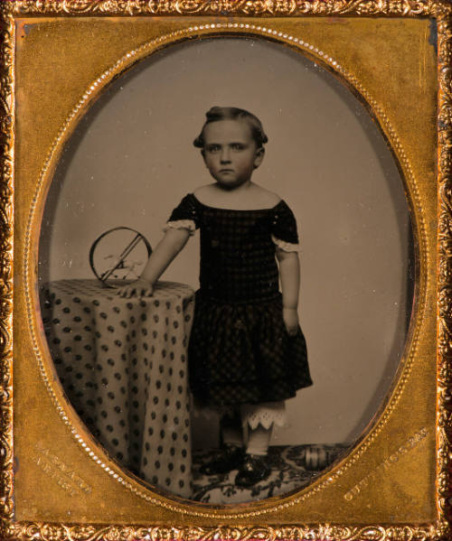 Young girl with toy horse