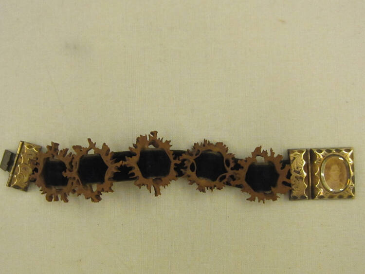 Peach-pit bracelet with daguerreotype portrait