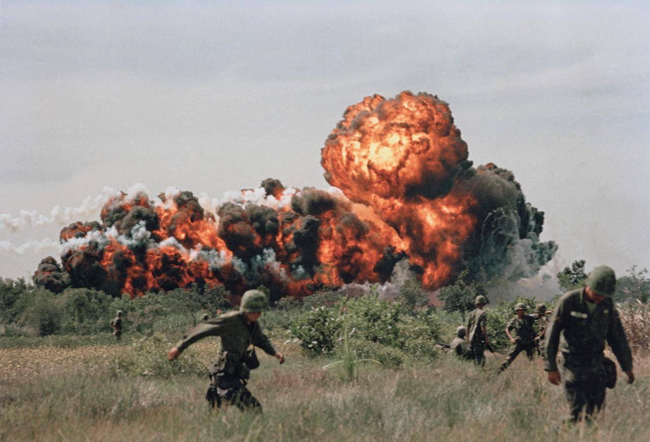 A Napalm Strike Erupts in a Fireball near U.S. Troops on Patrol in South Vietnam