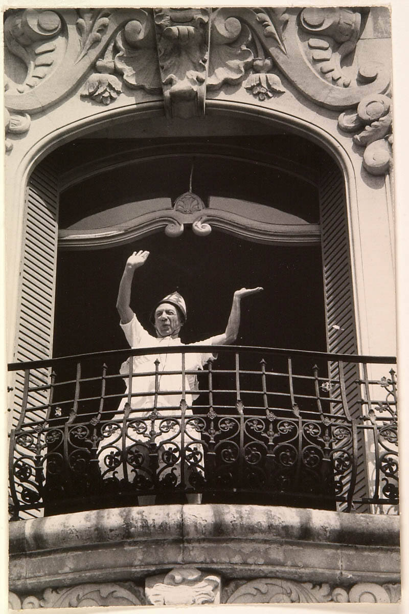Picasso, in African War Helmet and a Petticoat, Dances on Bedroom Balcony