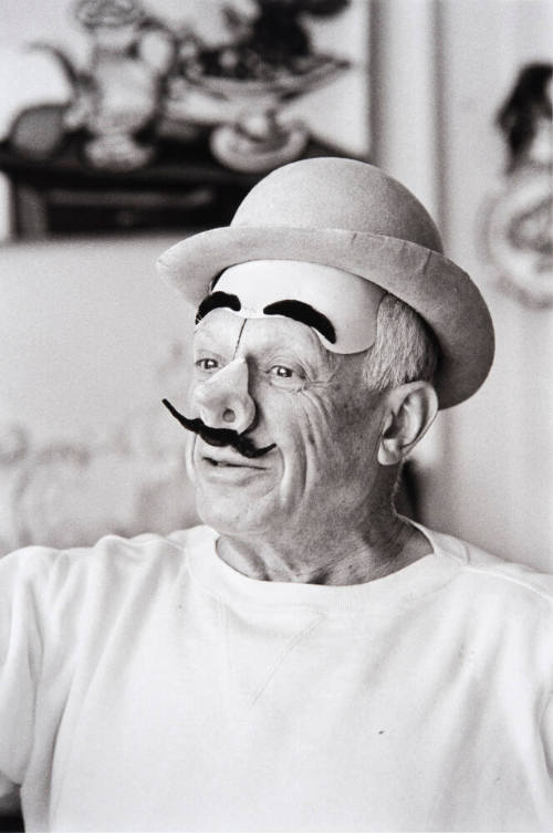 Pablo Picasso with a Clown Mask