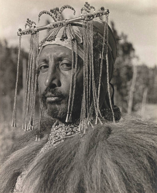 Emperor Haile Selassie's Master of the Hunt with gold headdress and lion hair cape. His name is Kenjazmatsch Kabala