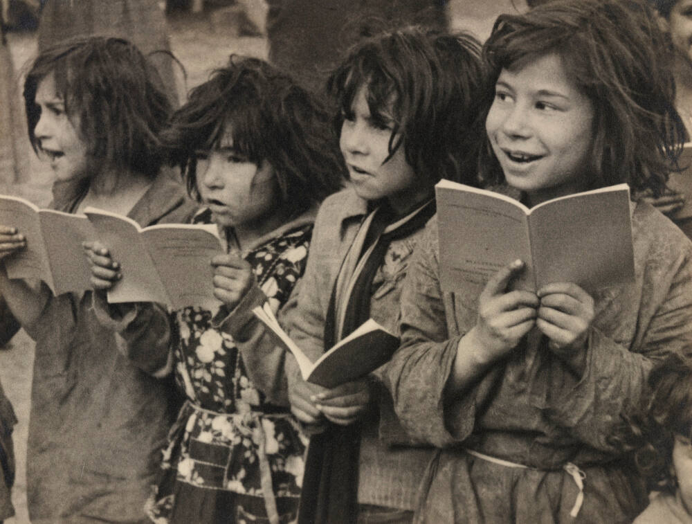 Gypsy children with books they don't know how to read, Yugoslavia