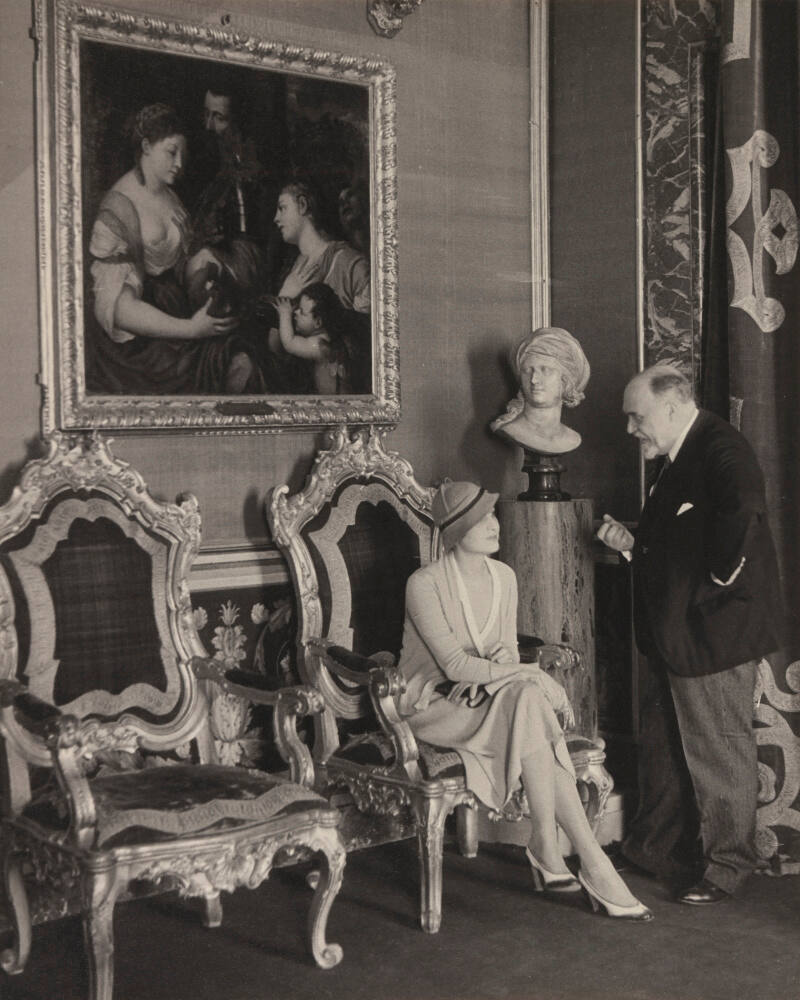 Papal Prince Francesco Massimo talking to socialite Claudia Mutio Vanutelli in the Palazza Massimo, Rome. Painting is a Titian