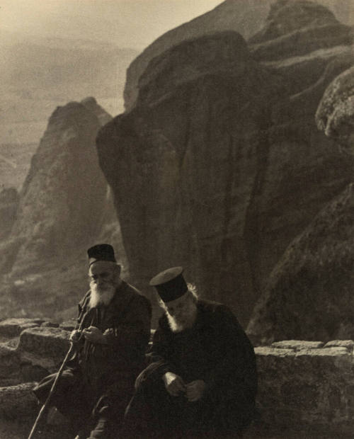 Two monks sitting on a patio of cloister Xylokastron in the mountain chain of the Meteora near Kalabaka, Greece